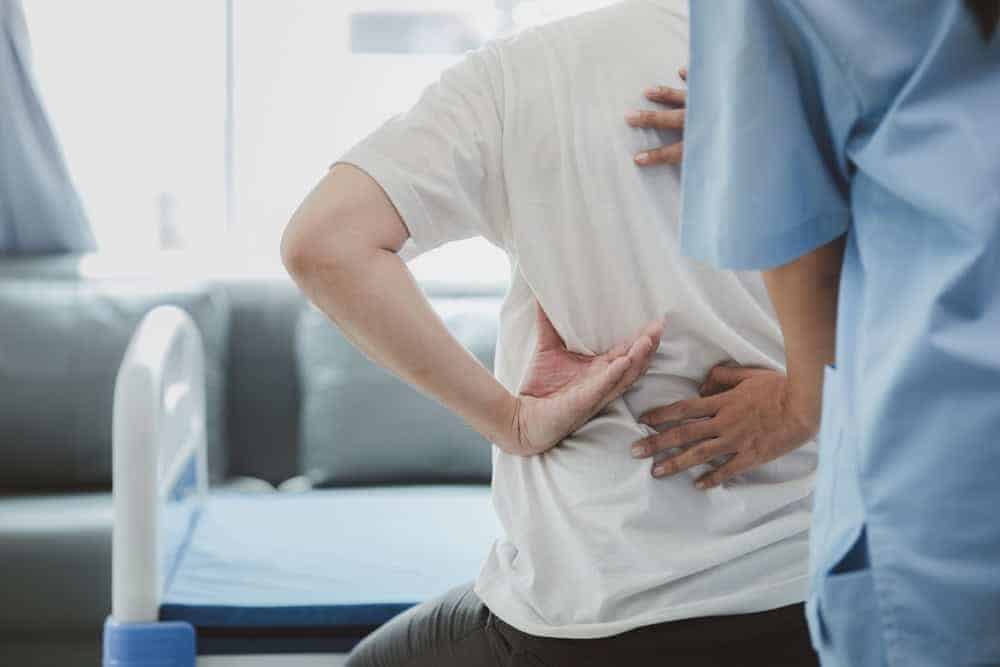 physiotherapist assessing senior man to create a personalized treatment plan