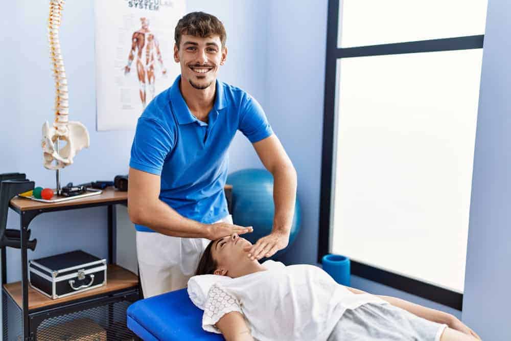 a young physiotherapist at work in an outpatient clinic