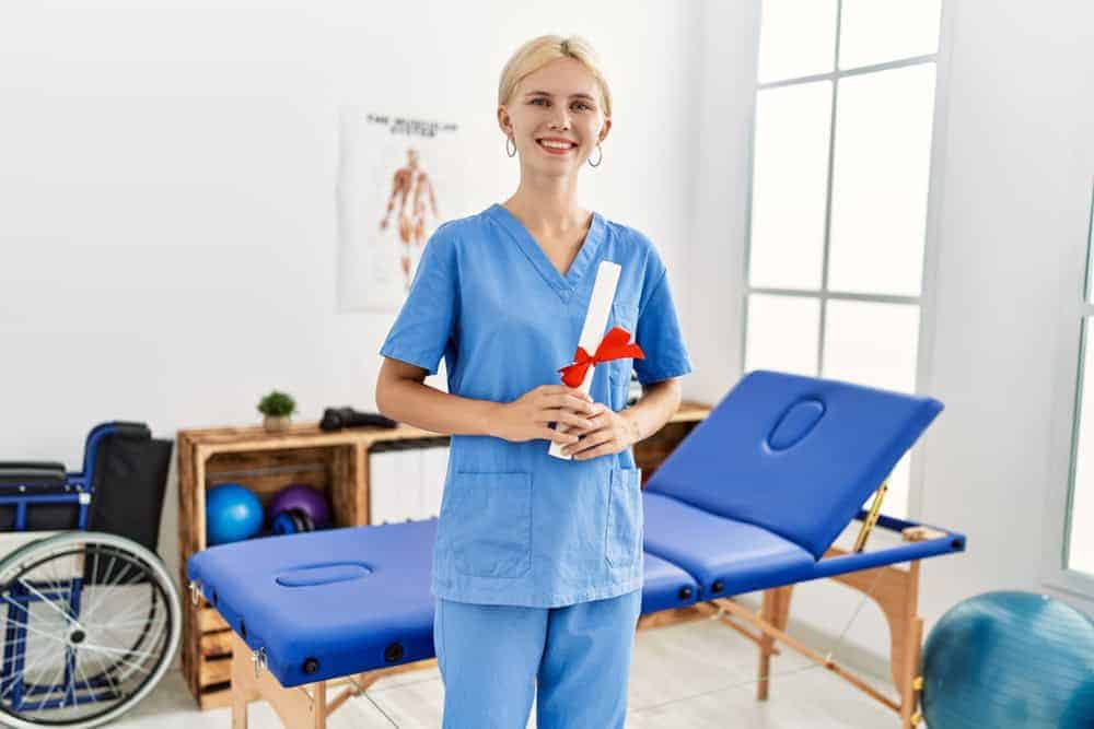 a young physiotherapist holding her certificate after graduation