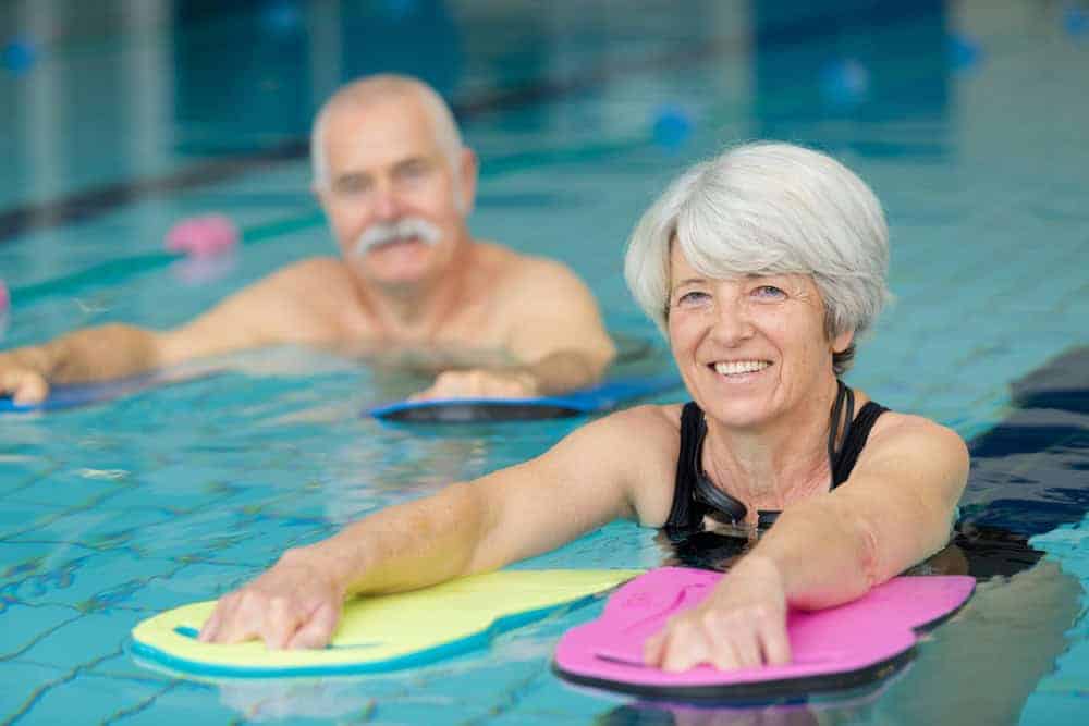 Seniors undergoing aquatic therapy in a pool | work with patients