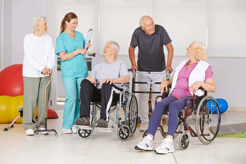 Group of happy seniors with a sports therapist