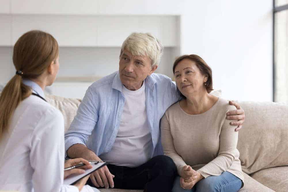 a therapist speaking with a couple about new care practices