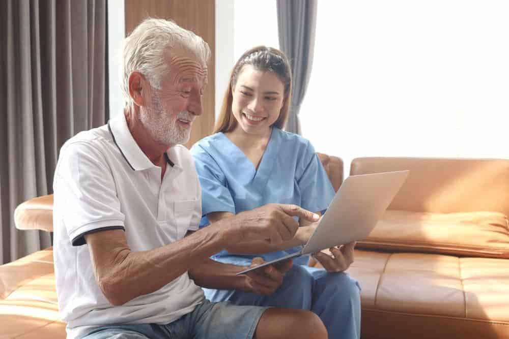 a healthcare professional discussing memory care costs with a resident's family member