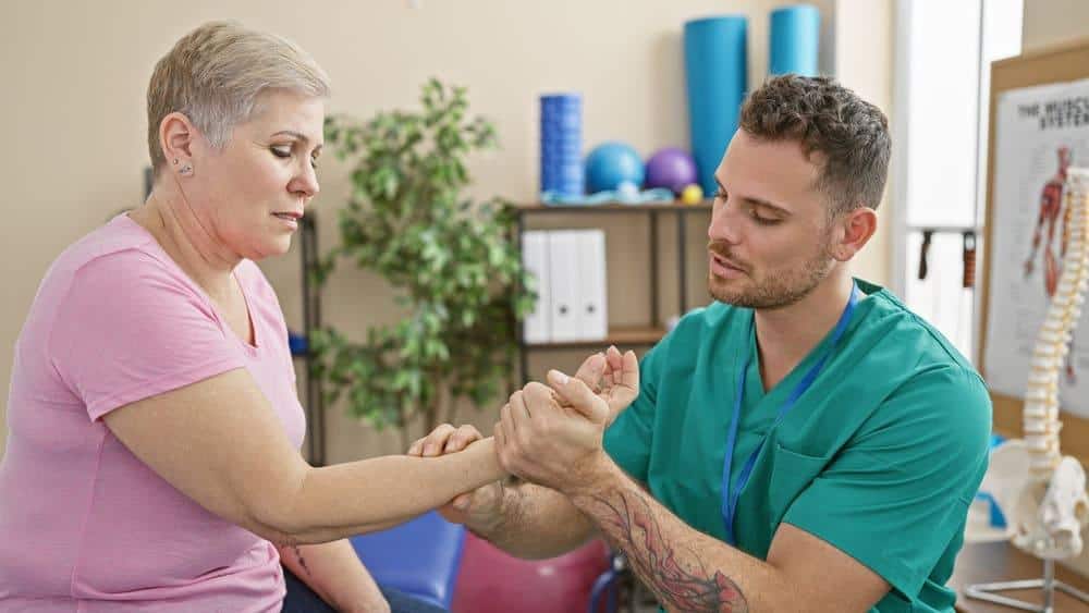 Senior Asian woman enjoying the psychological benefits of today's physical therapy techniques on her wrist and smiling