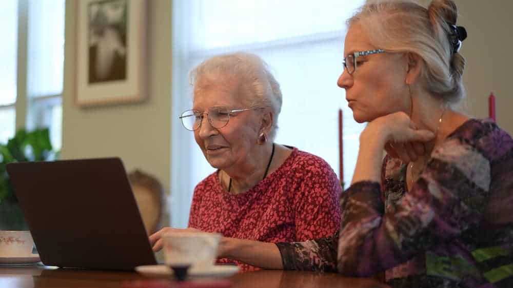 A young caregiver explaining to an older woman how she will be taking her medications | senior care