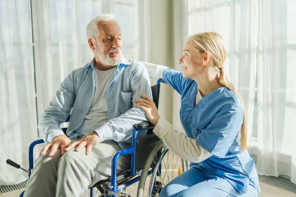 Female caregiver holding the hand of a senior - assisted living carson city