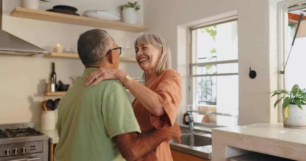 Senior couple dancing at home during covid-19 pandemic