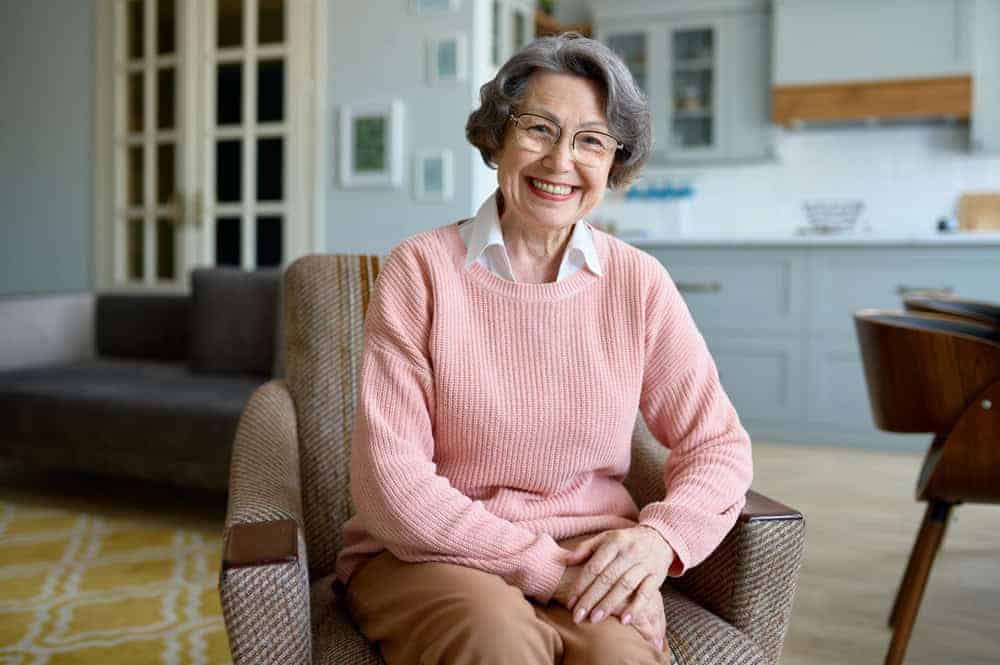 Older woman sitting in an armchair - covid friendly activities for seniors