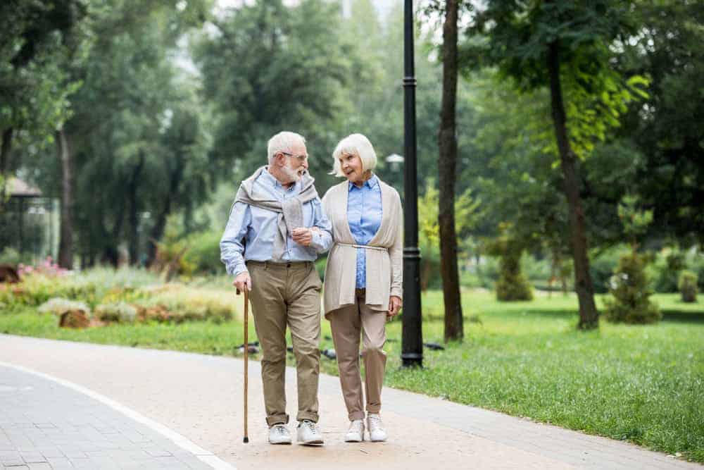 A senior couple taking a walk as part of their daily routine - how to care for someone with dementia