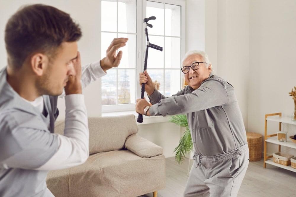 An agitated father with his son after a discussion of seeking dementia care for him