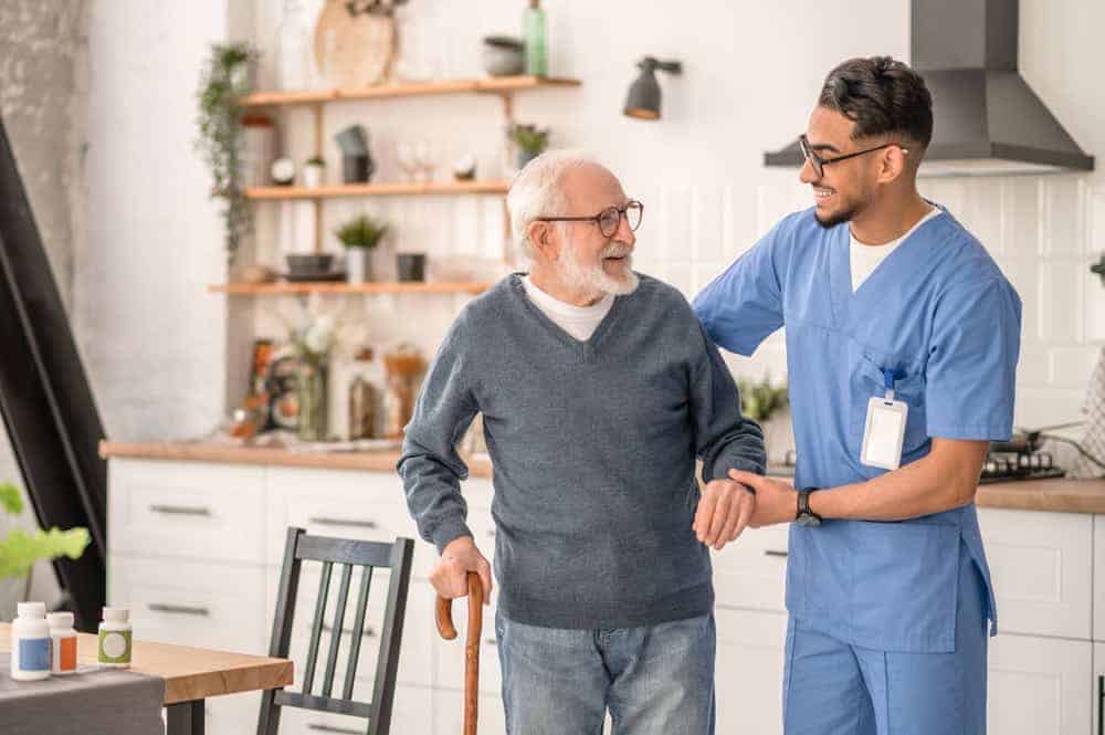 Smiling male with elderly man - home health care services