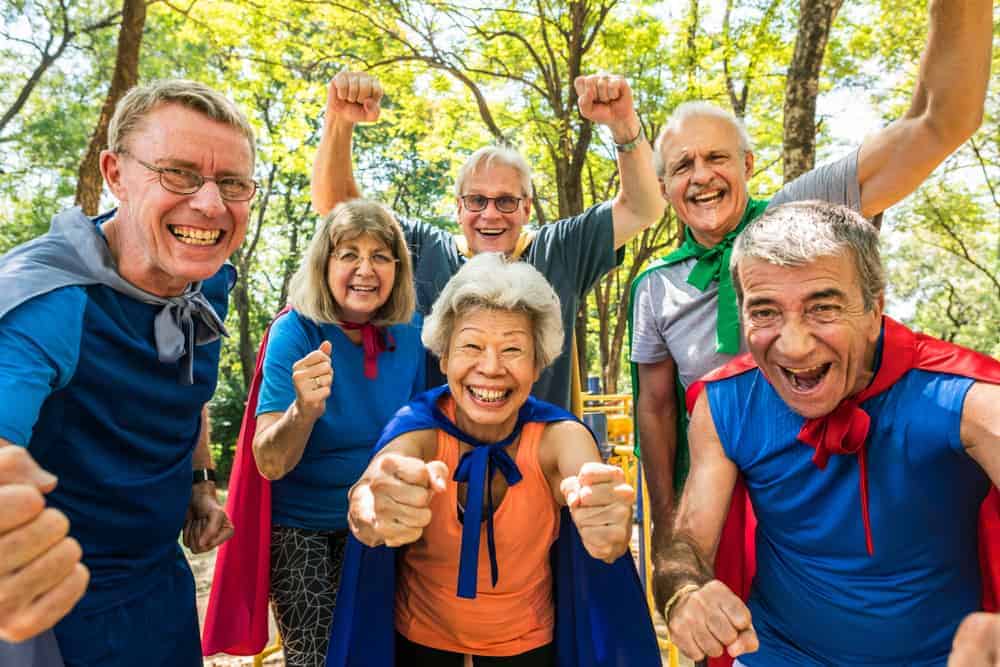 Happy seniors wearing superhero costumes - resources for caregivers of dementia