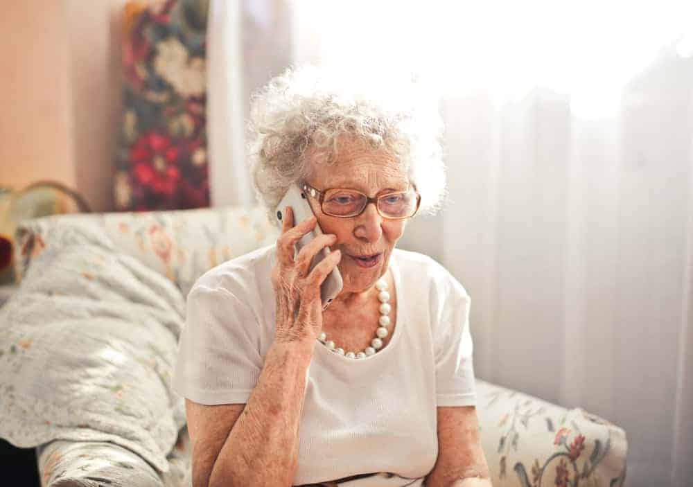 An elderly woman talking on the phone - dementia care resources