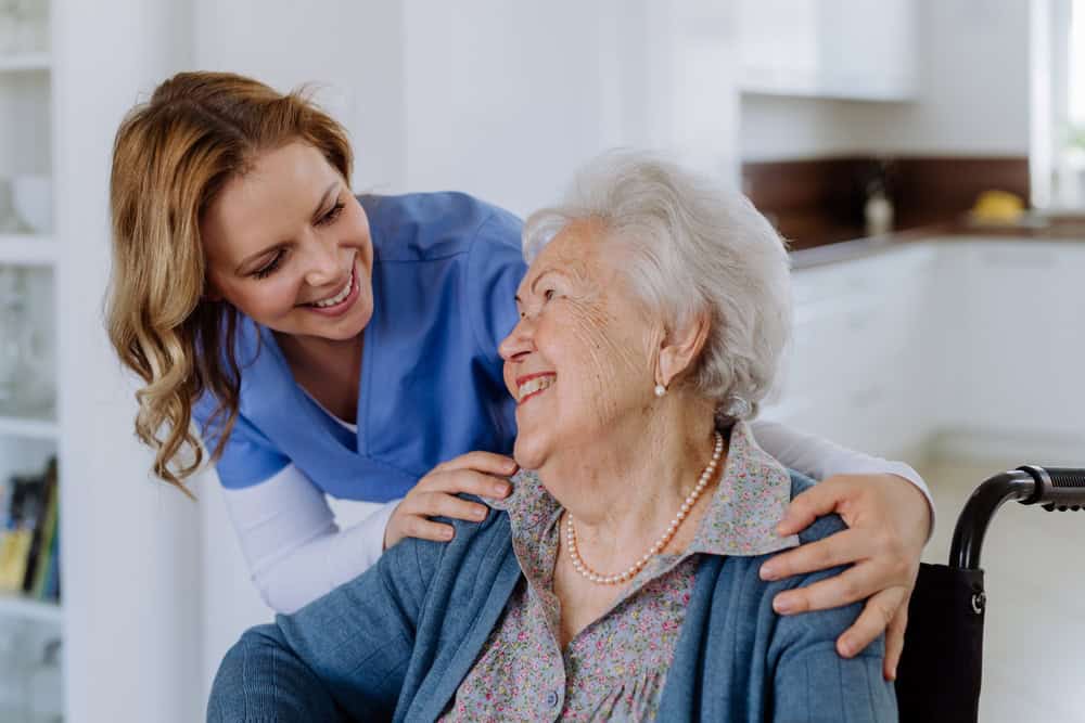 a 24/7 home caregiver engages a senior woman in meaningful communication