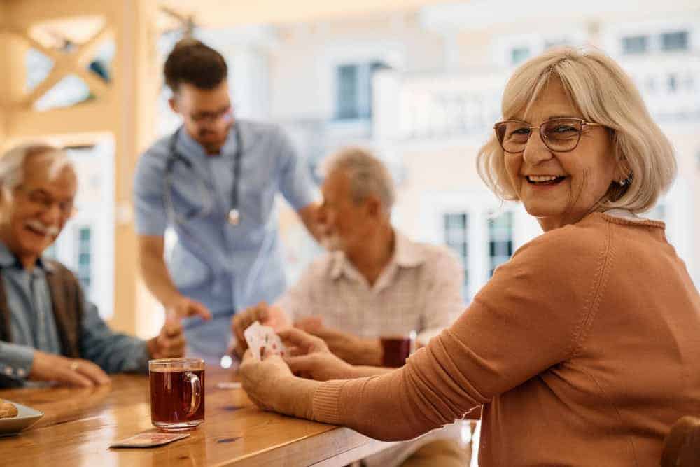 a group of seniors enjoying social and recreational activities at a long term care facility