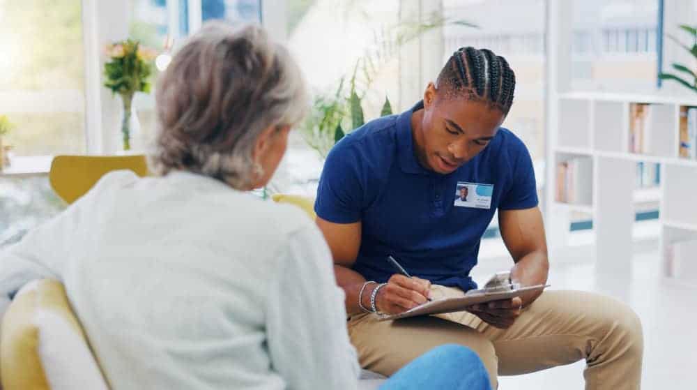 a caregiver discussing options of independent assisted living with a senior woman