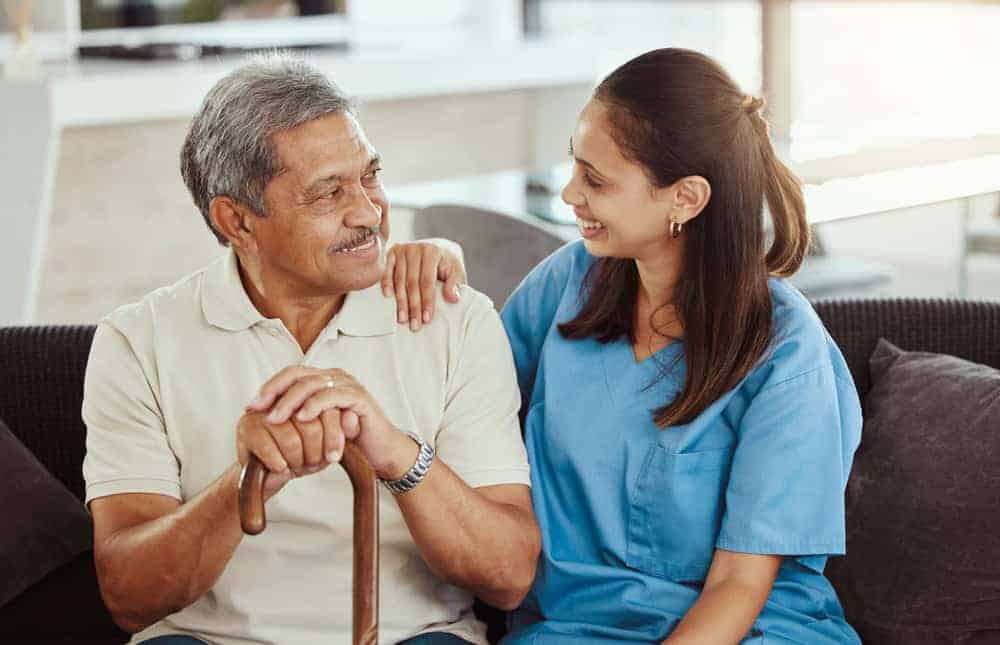 home health worker smiling with a senior man