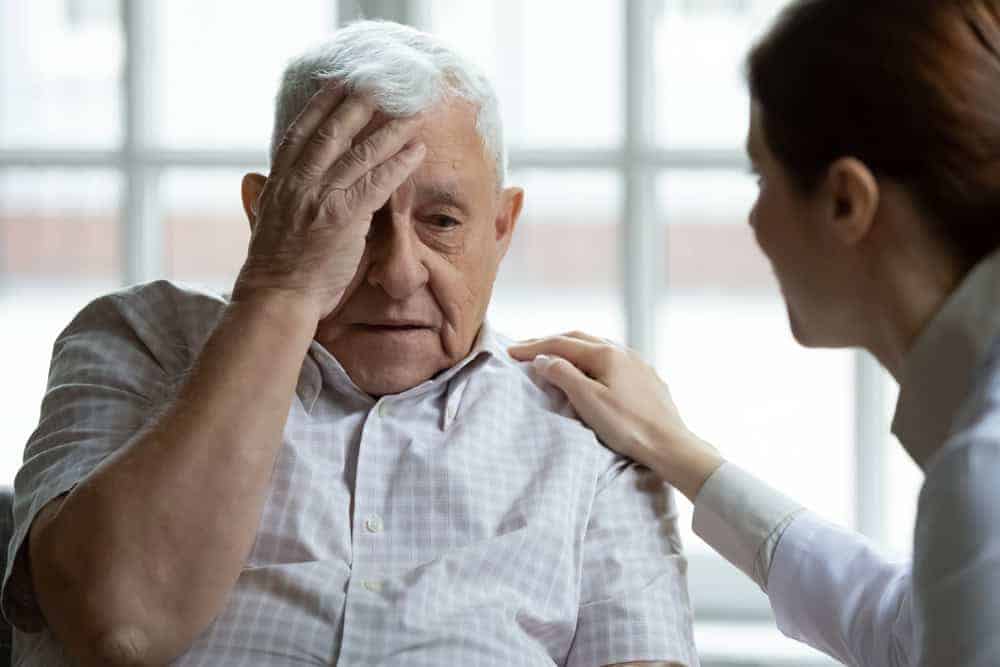 A female caregiver listening attentively to an elderly man's complaints - private elderly care jobs