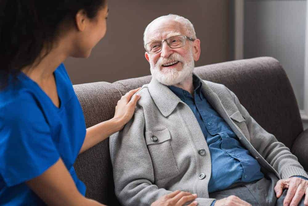 an older man happy after hiring home caretaker services to help him at his home