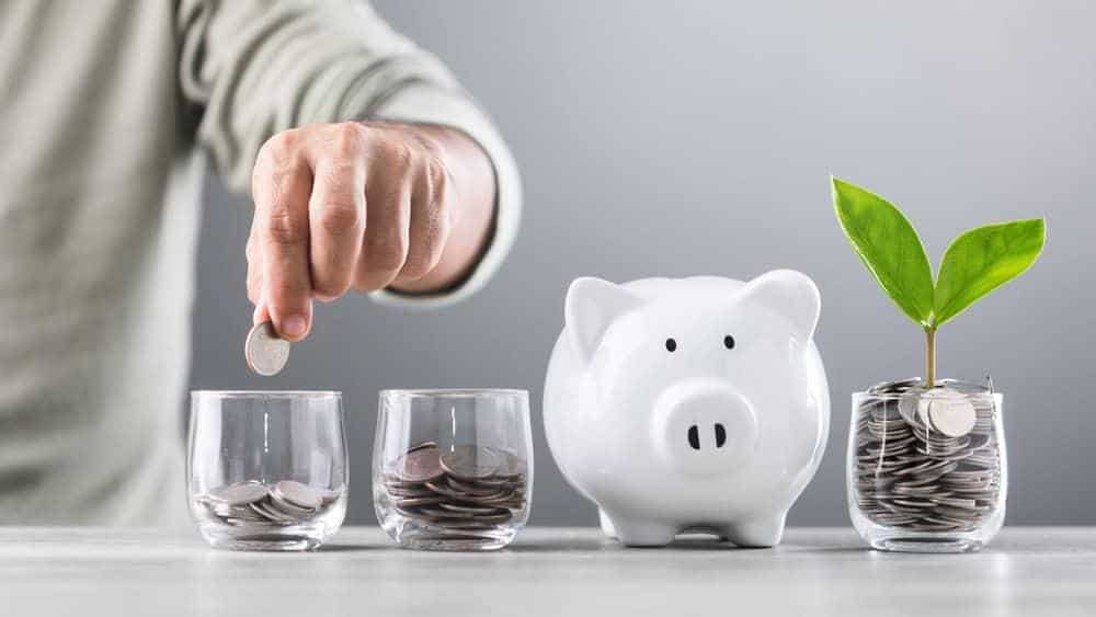 A man drops a coin in a glass, implying savings for the future | cost of in home nursing care