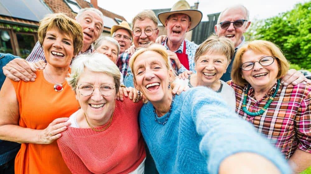 a group of happy seniors at a residential care community