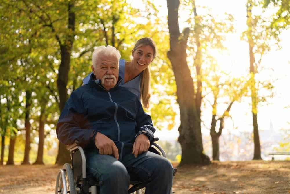 older gentleman with his caregiver spending time in the sunshine - overnight companion care