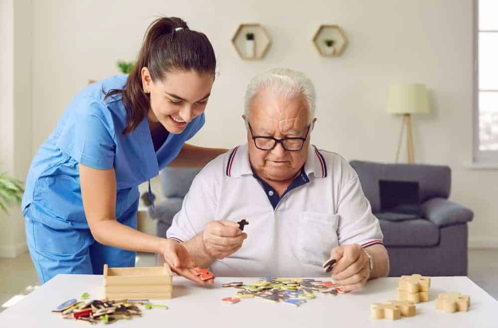 Nurse caregiver helping an older man with dementia - how much does it cost to hire a private nurse