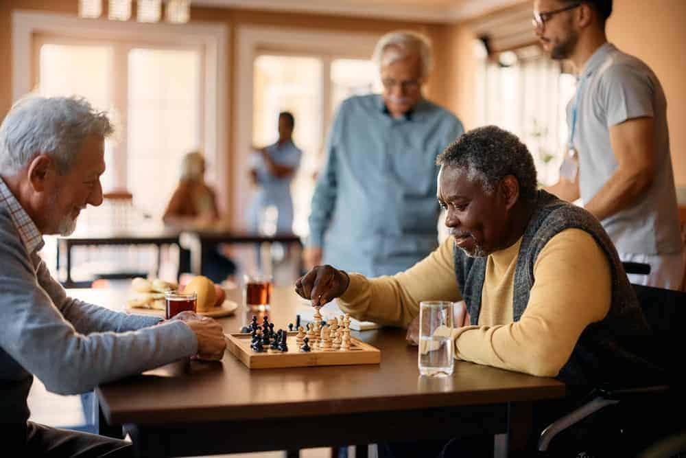 group of seniors playing chess in a residential care home