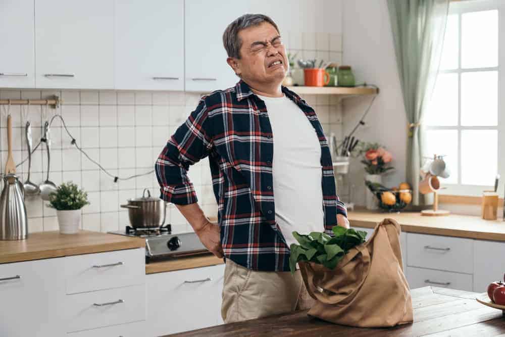 senior man in pain after grocery shopping I cooking nutritious recipes is essential