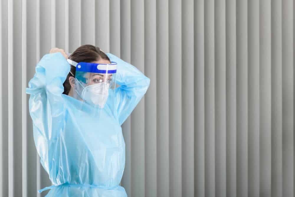 caregiver donning a face shield | personal protective equipment