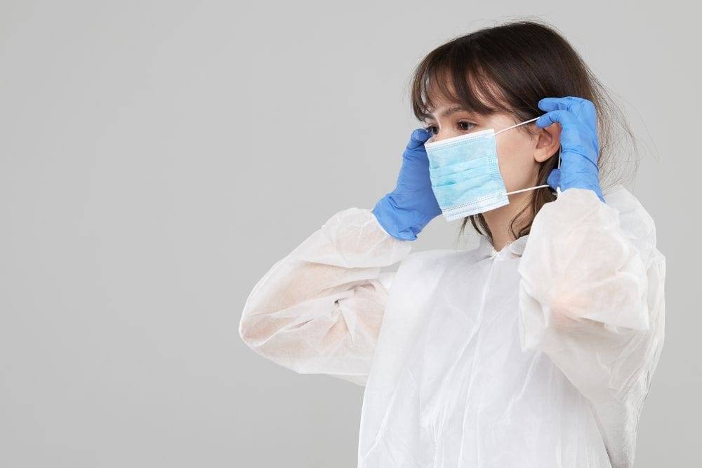 caregiver donning a surgical mask