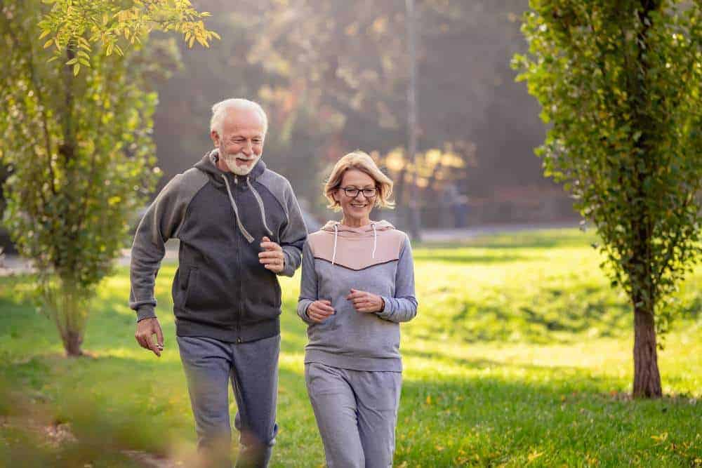 A senior couple happily running