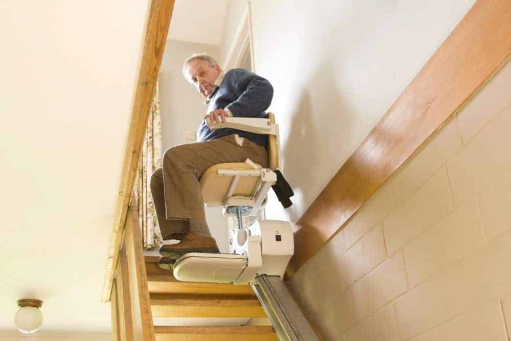 A senior man using the stairlift