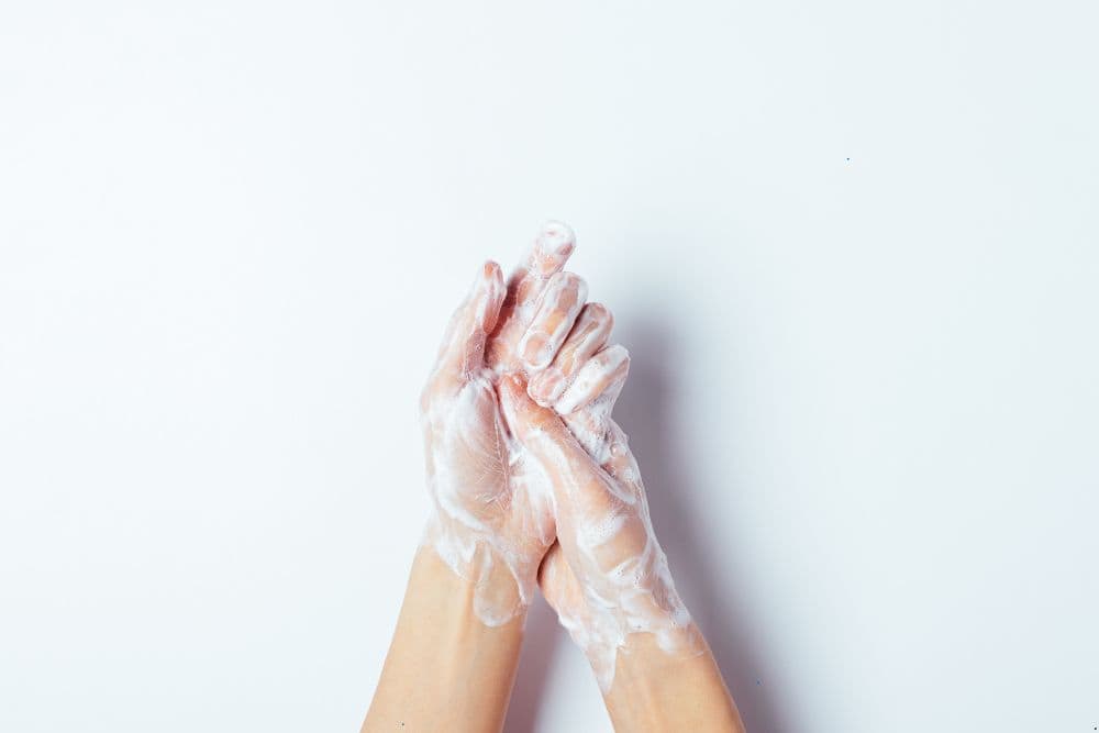 an older woman handwashing | prevent the spread