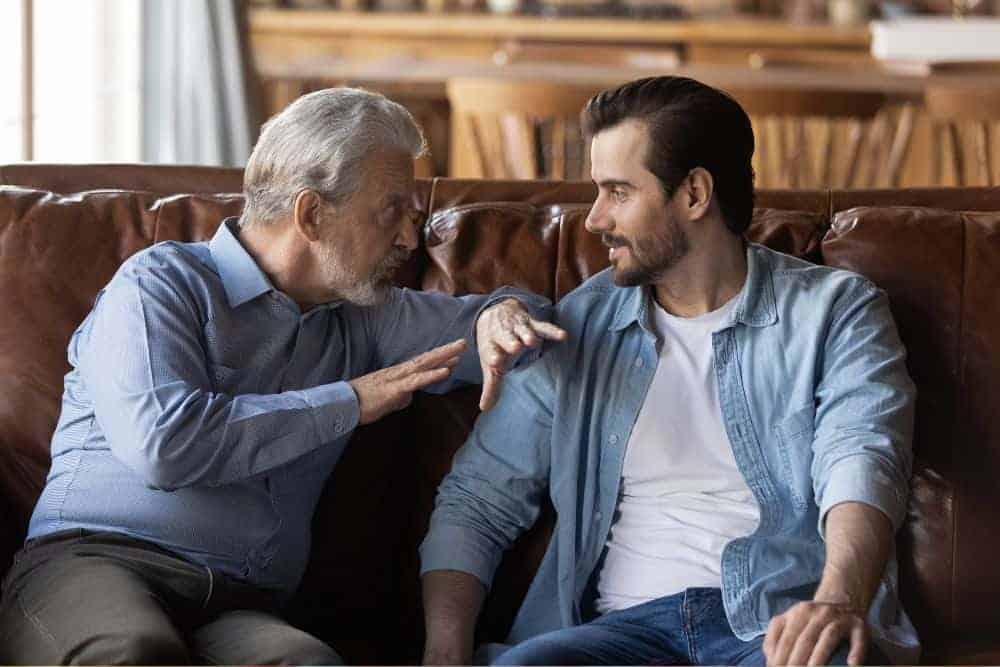 a senior gentleman in conversation with his son