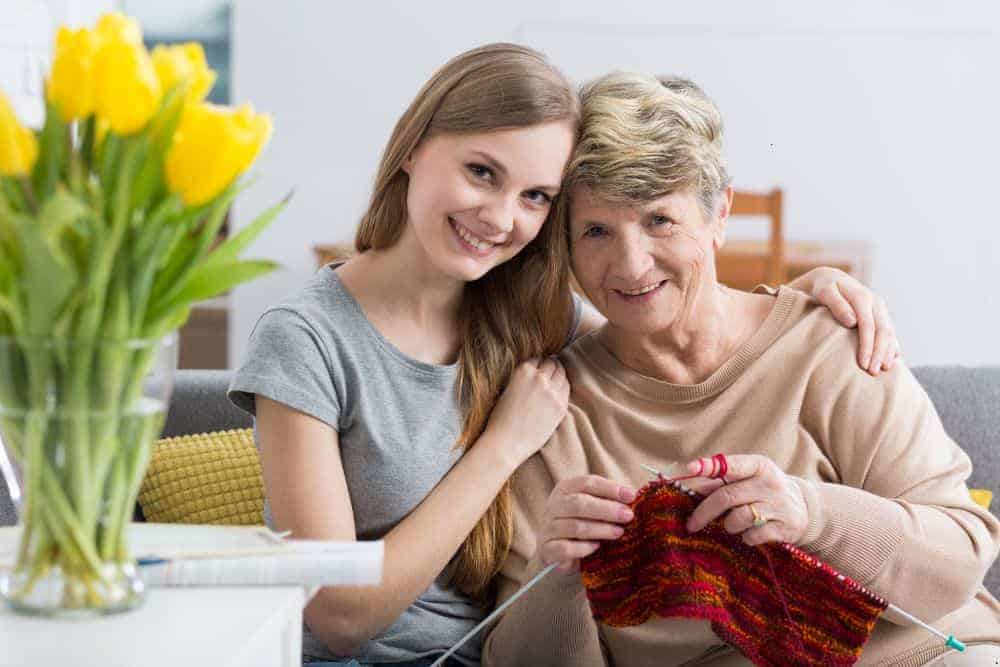 a younger and an older woman having respectful communication over a cup of tea