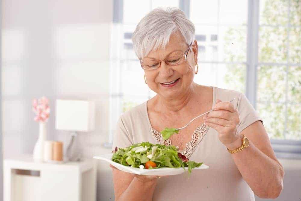 A Senior woman eating healthy meals to promote indepedence