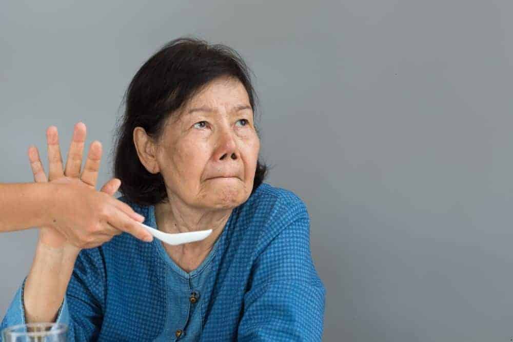 an older woman refusing to eat