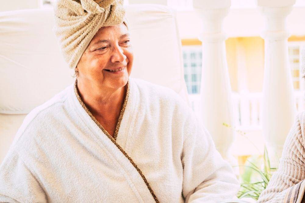 a caregiver is helping a senior bathe and clean up