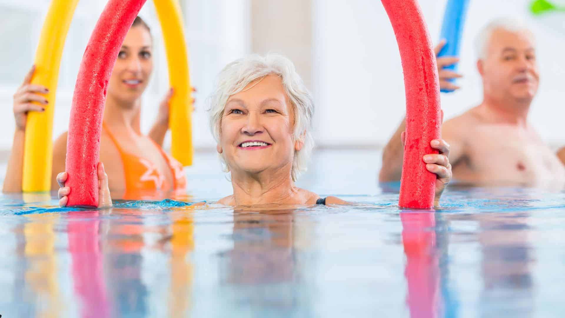 seniors doing aerobic exercises in water