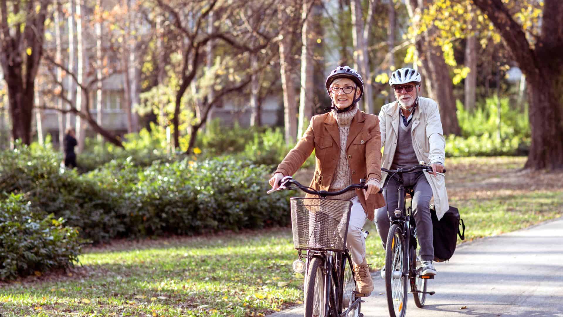 seniors cycling in a park