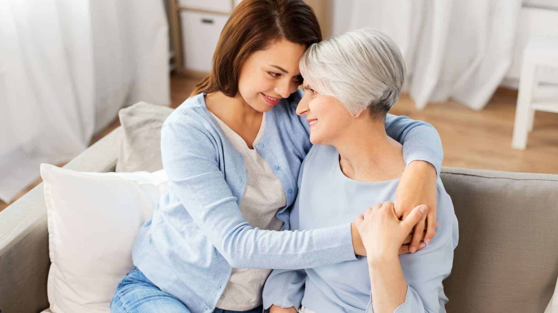 a happy mom and daughter at a residential care home where her caregivers treat her with dignity