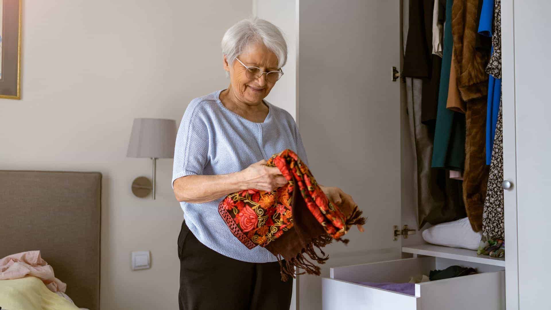 a senior woman choosing what to wear from her wardrobe before going out