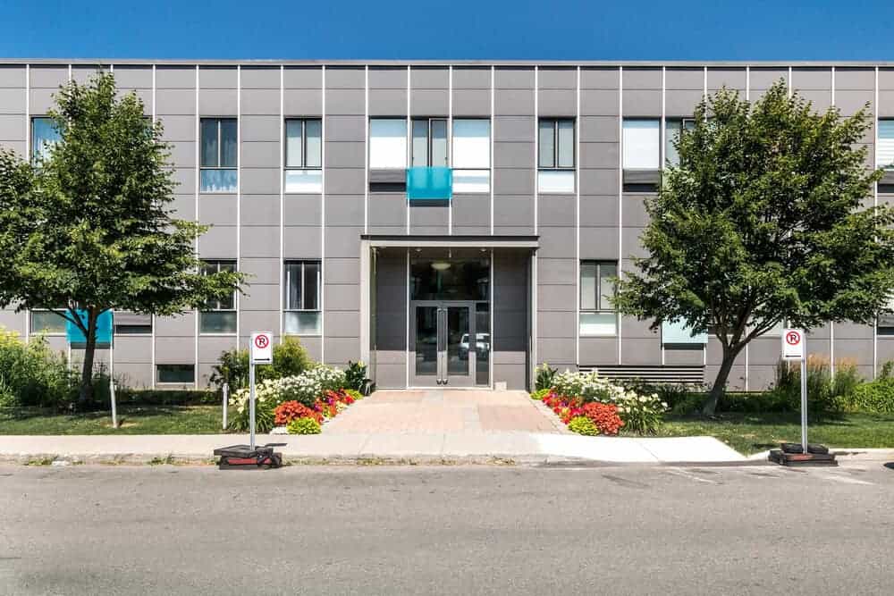 Entrance to a modern assisted living building on a sunny day Entrance to a modern assisted living building on a sunny day