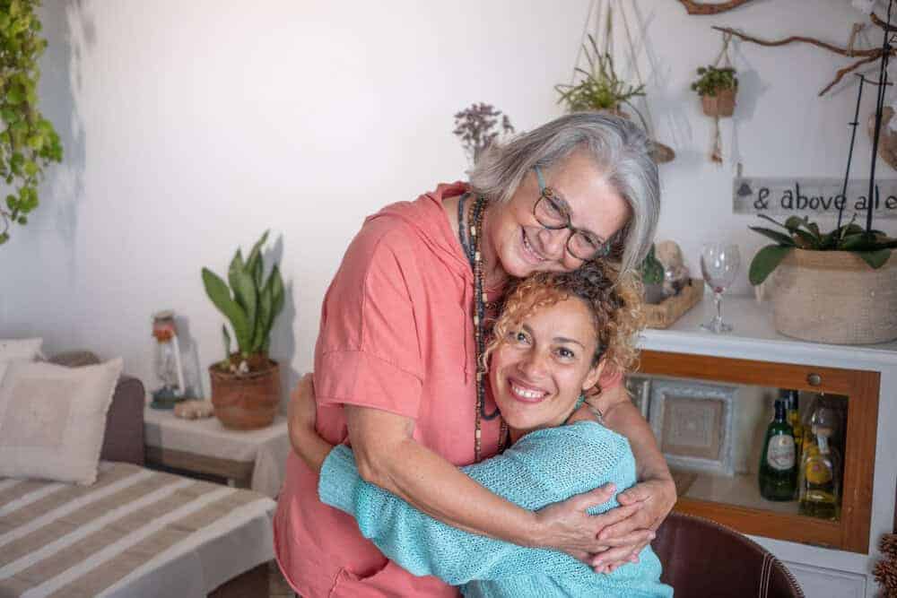 A caregiver and a resident sharing a happy moment in a cozy home-based care center in Reno
