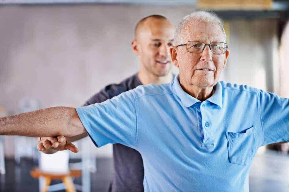 A senior man participating in a senior wellness program during a short stay at an assisted living home in Reno.