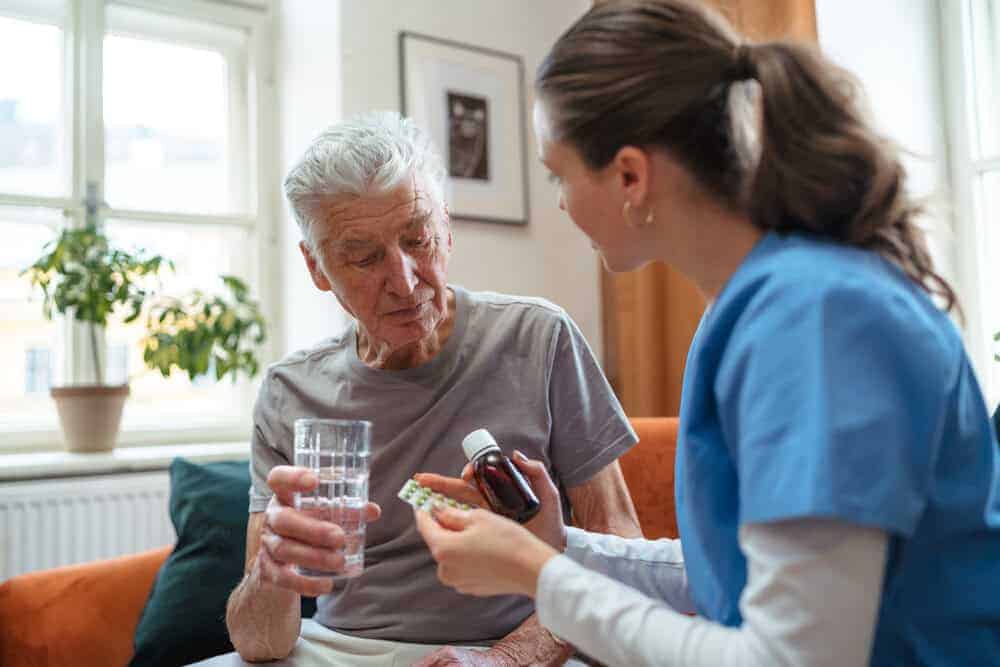 Caregiver providing medication management services for a senior during a respite stay in Reno.