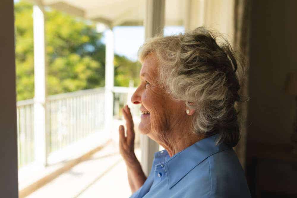 A senior woman feeling safe and happy in her new long-term care home in Carson City.