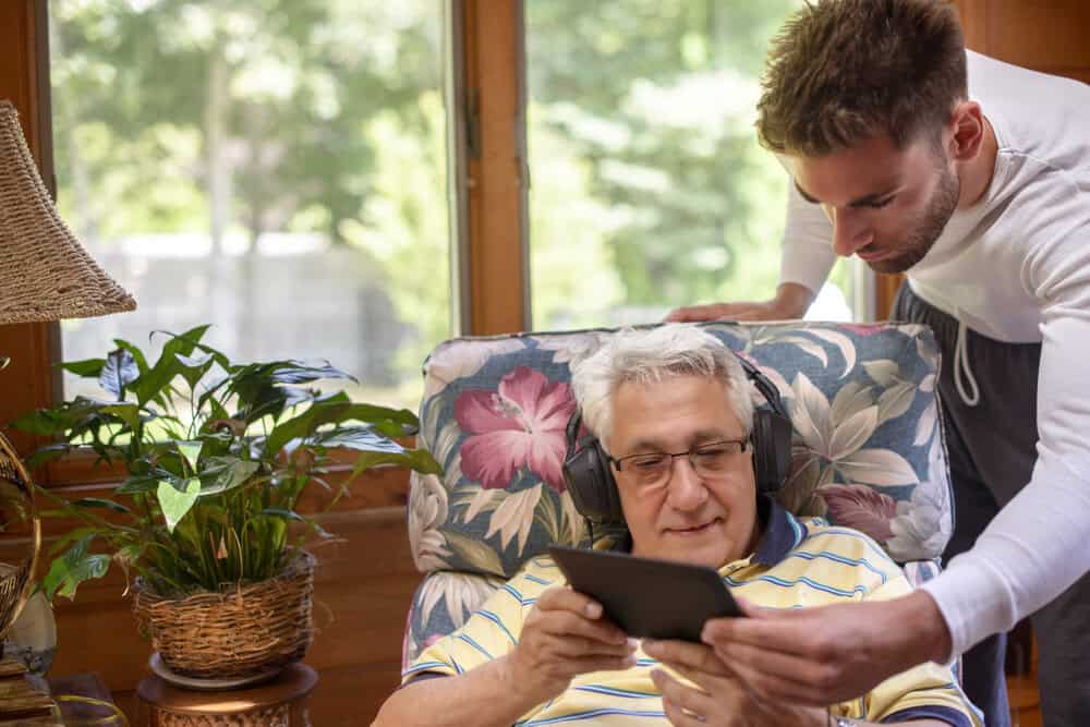 A resident enjoying personalized, one-on-one care in a home-based assisted living setting.
