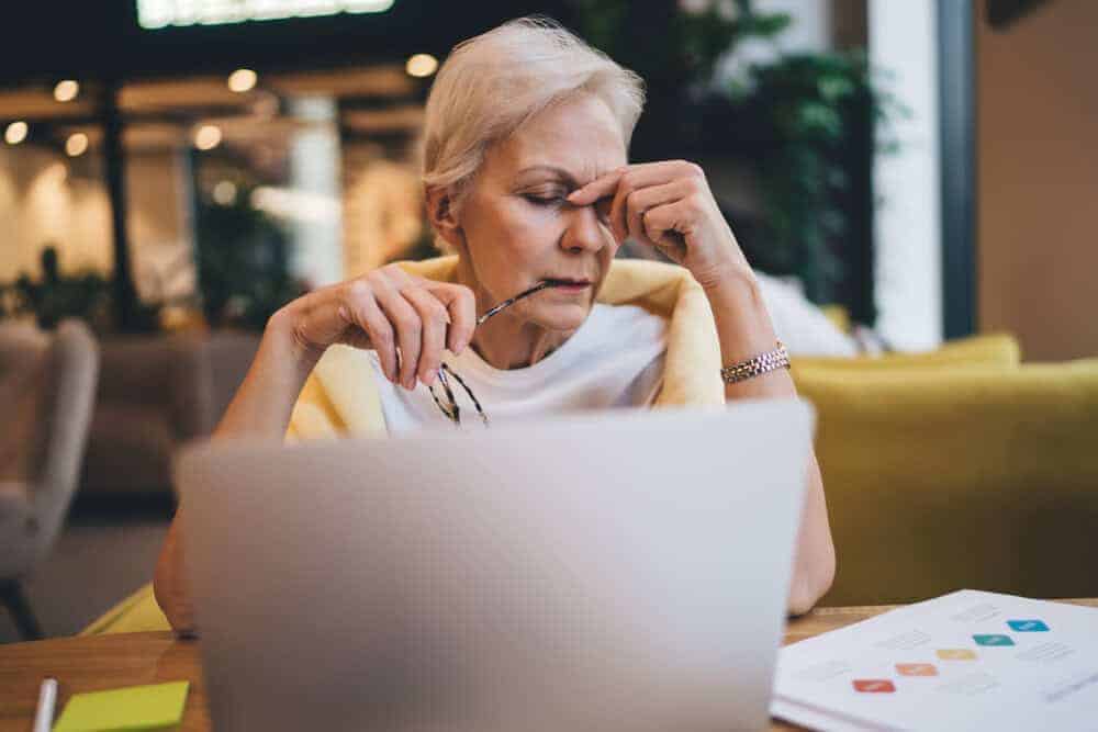A senior woman in Reno looking stressed while managing the costs of in-home care.